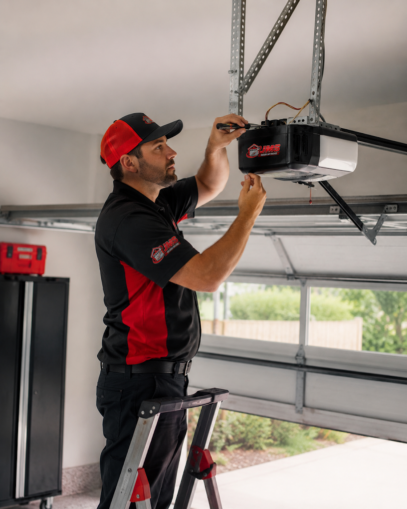 Jims Garage Door Repair technician servicing a garage door opener in Ardmore PA